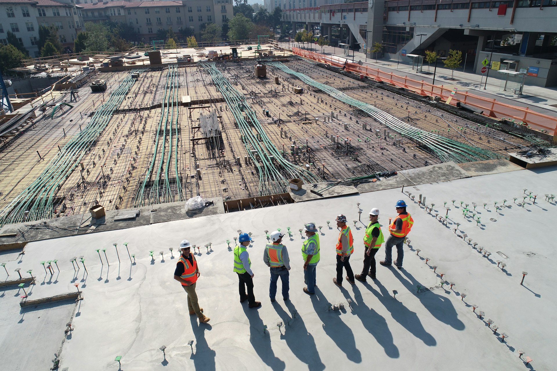  construction workers standing on white field